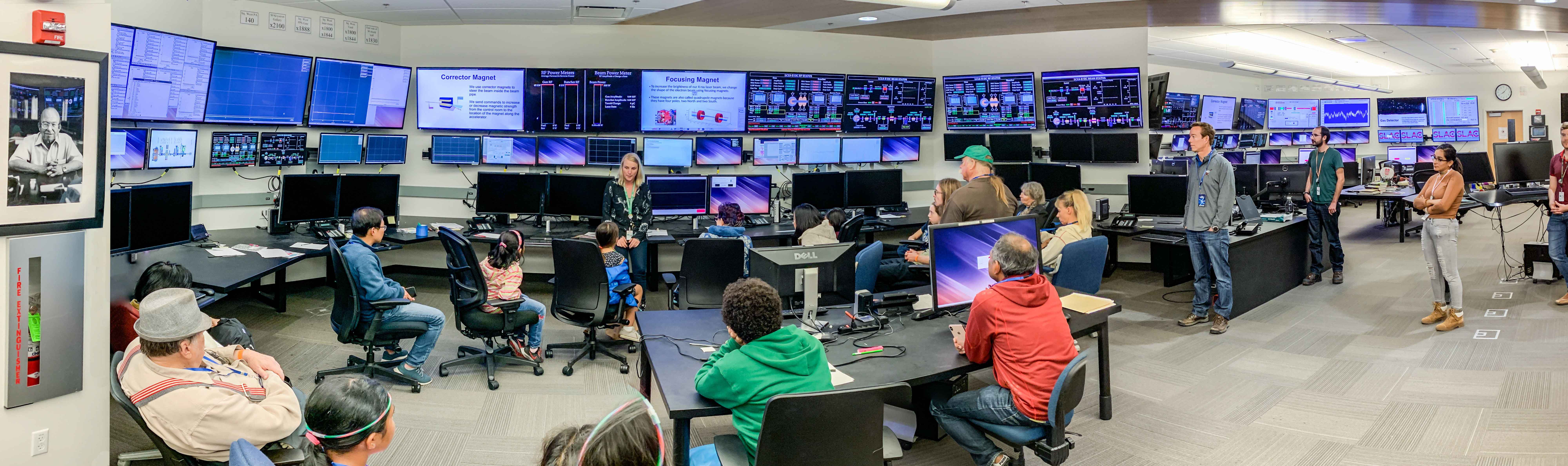 Tour participants visit an accelerator control room on community day
