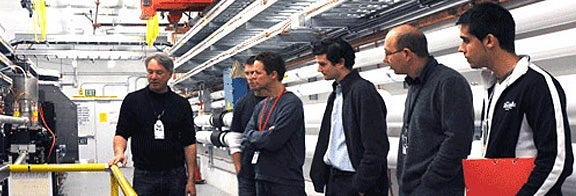 PHOTO: Group of people being led on a tour through a SLAC facility