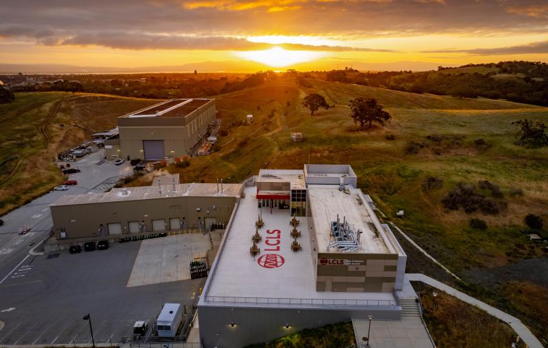SLAC’s Linac Coherent Light Source (LCLS) Near Experimental Hall building at sunrise with Stanford University Hoover Tower in the background.