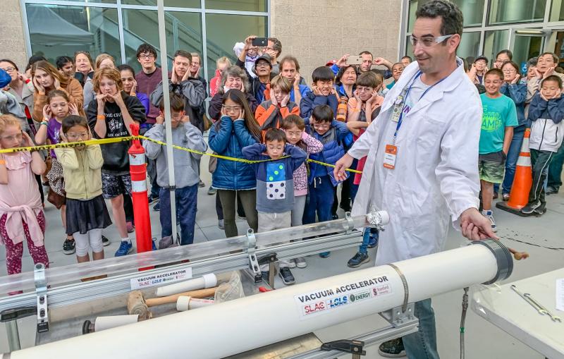 Visitors watch a science demonstration at Community Day 2019