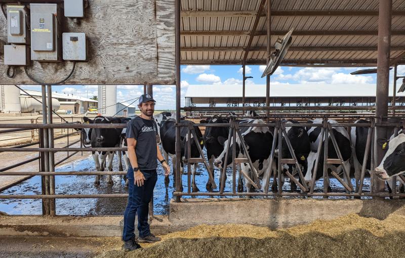 SLAC engineer Gustavo Cezar stands at a dairy farm in Central California.