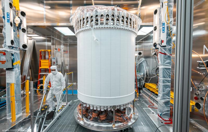 A tall white cylinder stands in a clean room space.