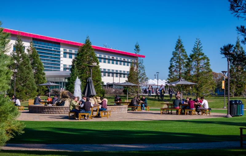 Staff members at SLAC having lunch on the main quad outside the Science and User Support Building