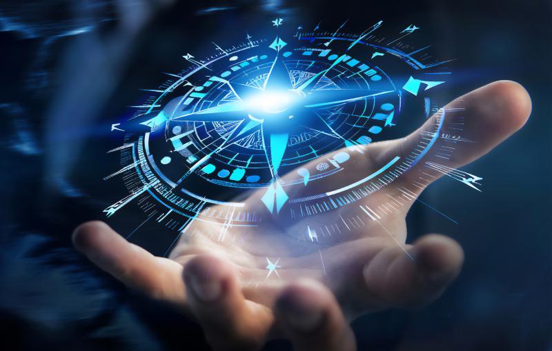 Hand holding a compass made with blue light