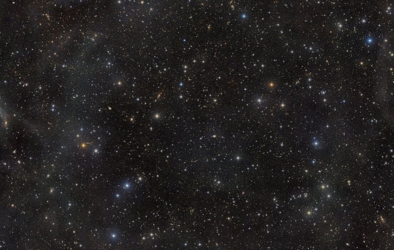 Field of night sky with stars and galaxies