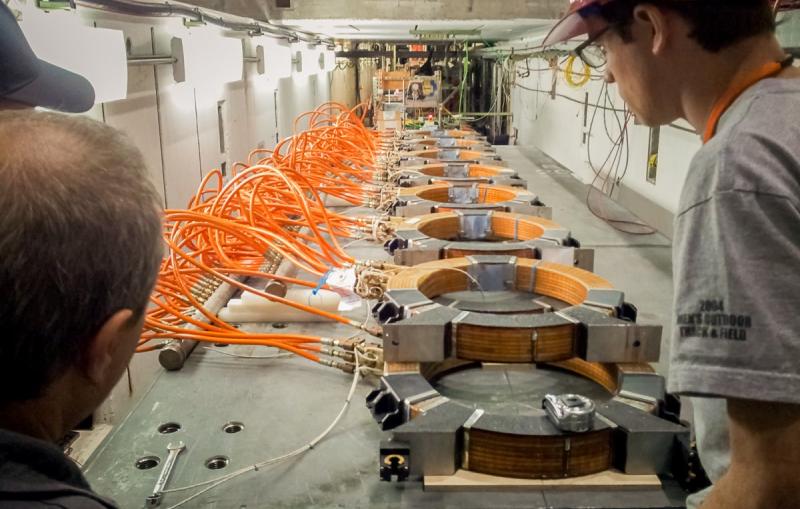 Photo - Researchers look over the magnetic coils that will impersonate the Earth's magnetic field.