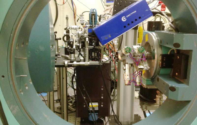 Photo - A view of a materials science experimental setup at SLAC's Stanford Synchrotron Radiation Lightsource (SSRL). The circular instrument that frames this photo is part of a diffractometer that was used to align samples and a detector with X-rays.