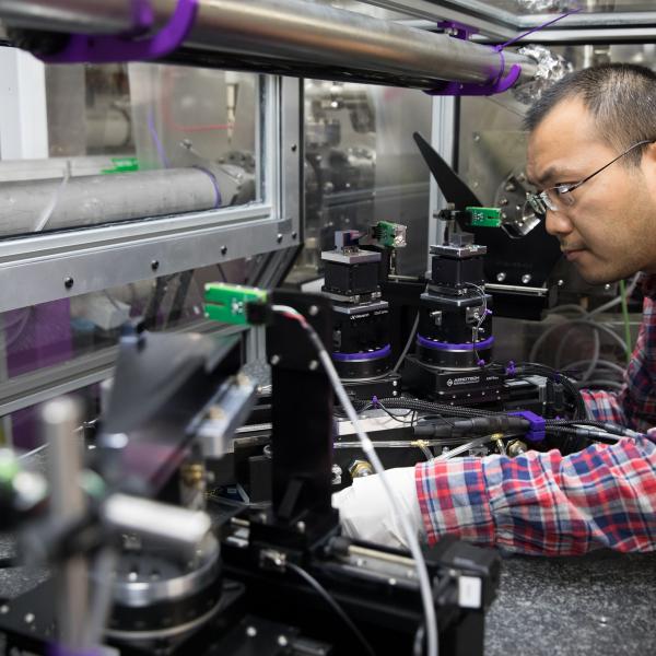 SLAC mechanical engineer Hongliang Shi inspects new equipment that splits the LCLS X-ray beam.