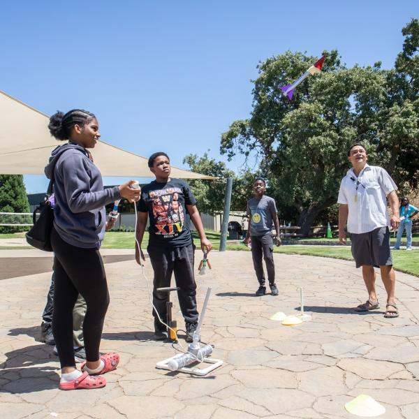 Students launch a paper rocket.