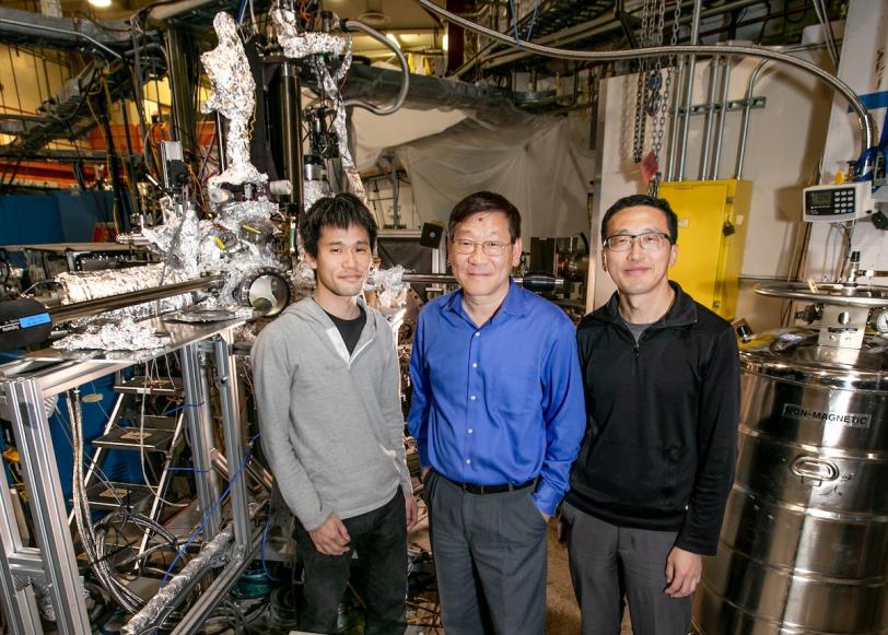 Portrait of three researchers -Makoto Hashimoto, Zhi-Xen Shen and Donghui Lu - with equipment they used to carry out their work at SLAC's Stanford Synchrotron Radiation Lightsource.  