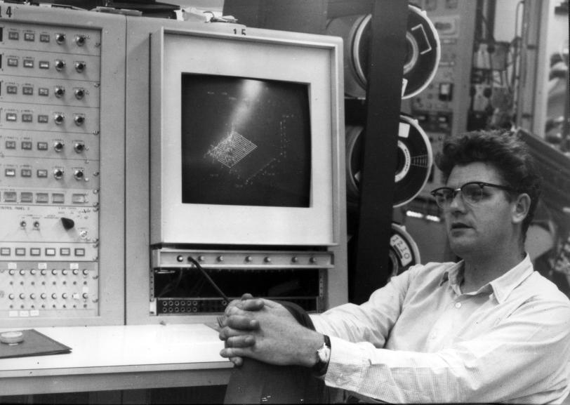 A 1967 photo of Richard Taylor in front of a computer monitor displaying experimental data. 