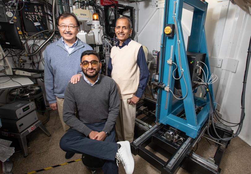 Researchers stand near SSRL's Beam Line 12-2. From left, Soichi Wakatsuki, co-senior author and professor at SLAC and Stanford; Suman Pokhrel, Stanford University graduate student in chemical and systems biology and one of the paper’s lead authors; and Irimpan Mathews, SSRL lead scientist and co-author.