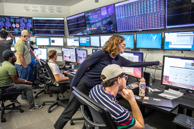 This is a photograph of SLAC employees watching for a signal of the first electron bunch in the superconducting accelerator.