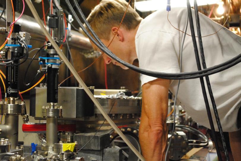 This is a photograph of FACET-II director, Mark Hogan. Mark is inside of FACET-II and he is inspecting equipment.