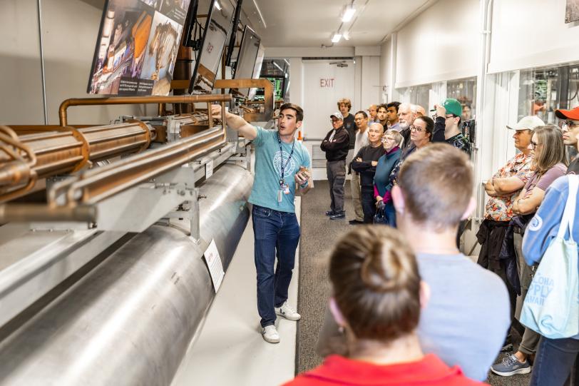 A tour guide explaining our accelerator in the Klystron Gallery at SLAC