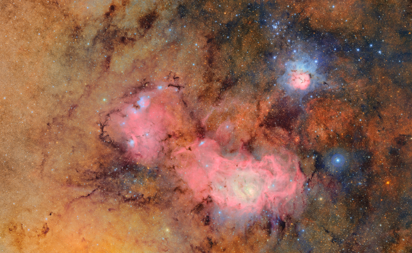 This image combines 678 separate images taken by NSF–DOE Vera C. Rubin Observatory in just over seven hours of observing time. Combining many images in this way clearly reveals otherwise faint or invisible details, such as the clouds of gas and dust that comprise the Trifid nebula (top) and the Lagoon nebula, which are several thousand light-years away from Earth