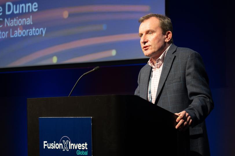 LCLS Director Mike Dunne speaks from a podium at FusionXInvest : Global Event.