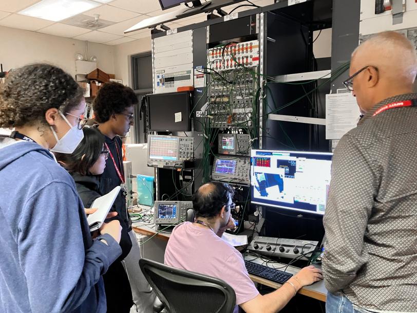  team from Harvey Mudd College watches Dhar, an NLCTA operator, move their detector into the electron beam.