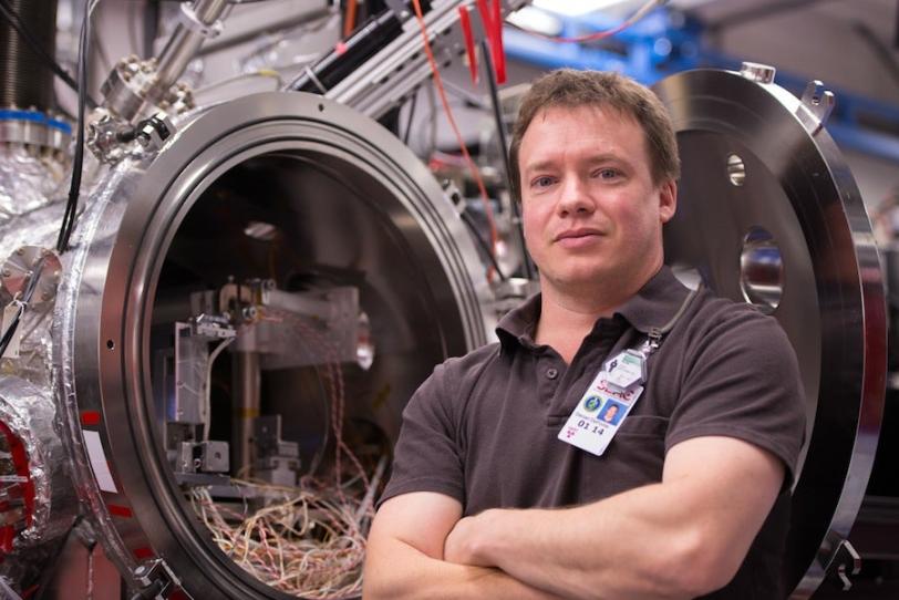 Photo - Daniel DePonte standing in experimental station.