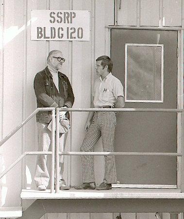 Photo - William Spicer, left, and Ingolf Lindau talk at the Stanford Synchrotron Radiation Project (SSRP) building in this 1977 photo. (SLAC Archives and History Office)