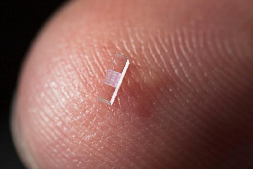 The key to the accelerator chips is tiny, precisely spaced ridges, which cause the iridescence seen in this close-up photo. (Brad Plummer/SLAC)