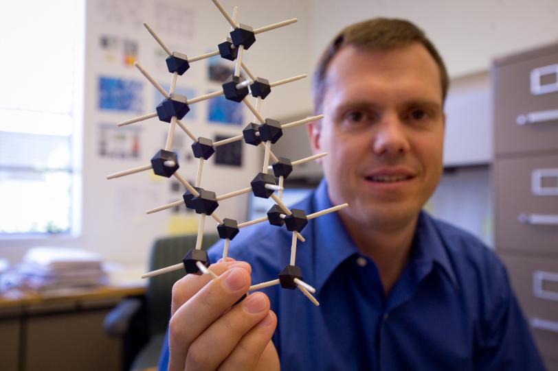 Nick Melosh holds a model of a diamondoid
