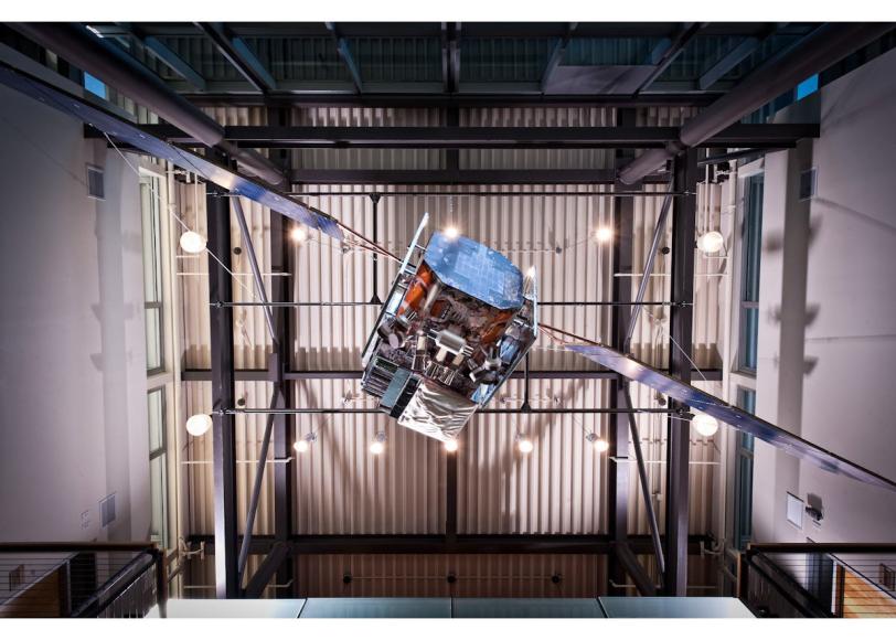 half-sized Fermi telescope model hovers over visitors