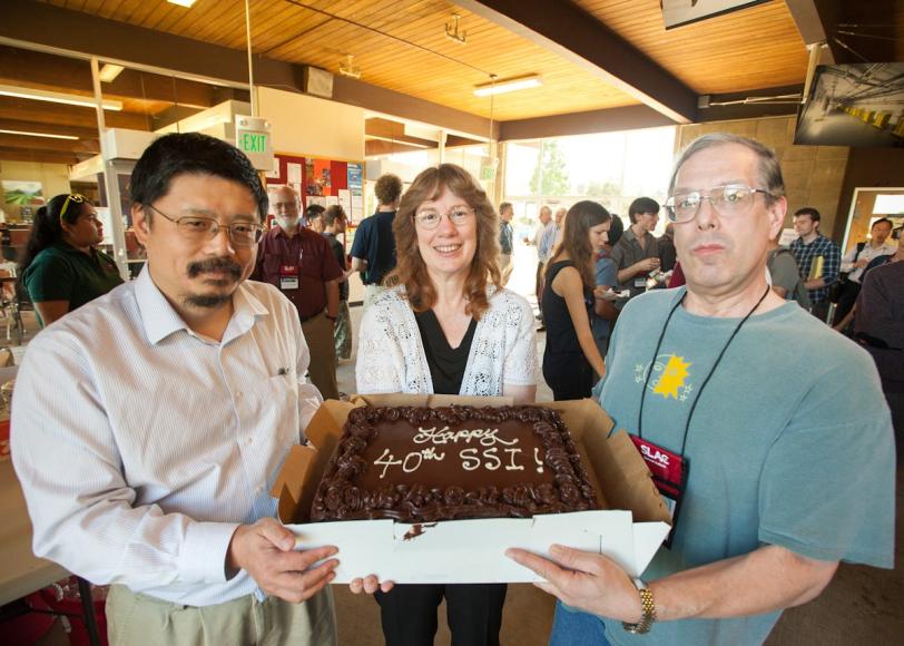 Su Dong and Tom Rizzo display a SLAC Summer Institute birthday cake