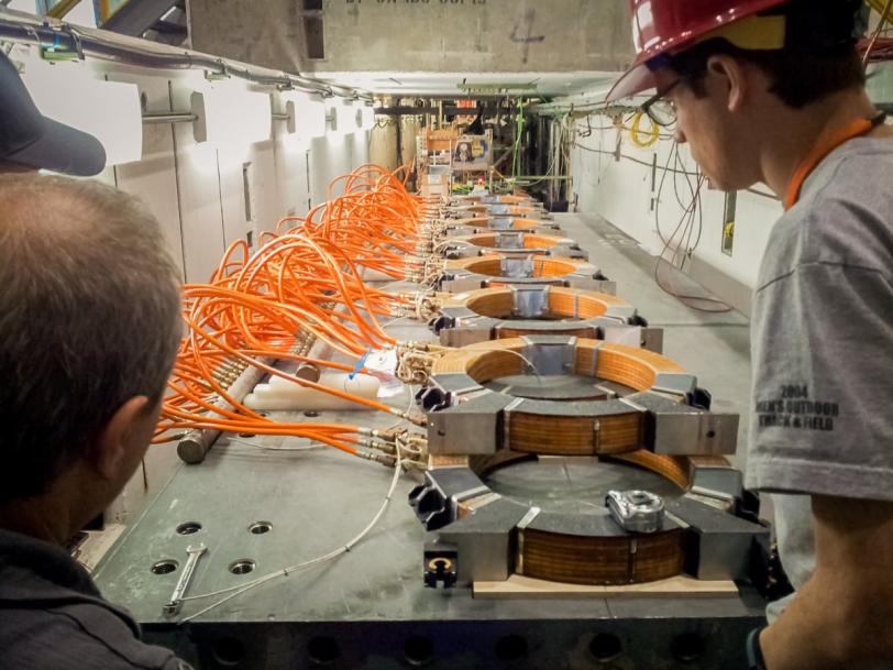 Photo - Researchers look over the magnetic coils that will impersonate the Earth's magnetic field.