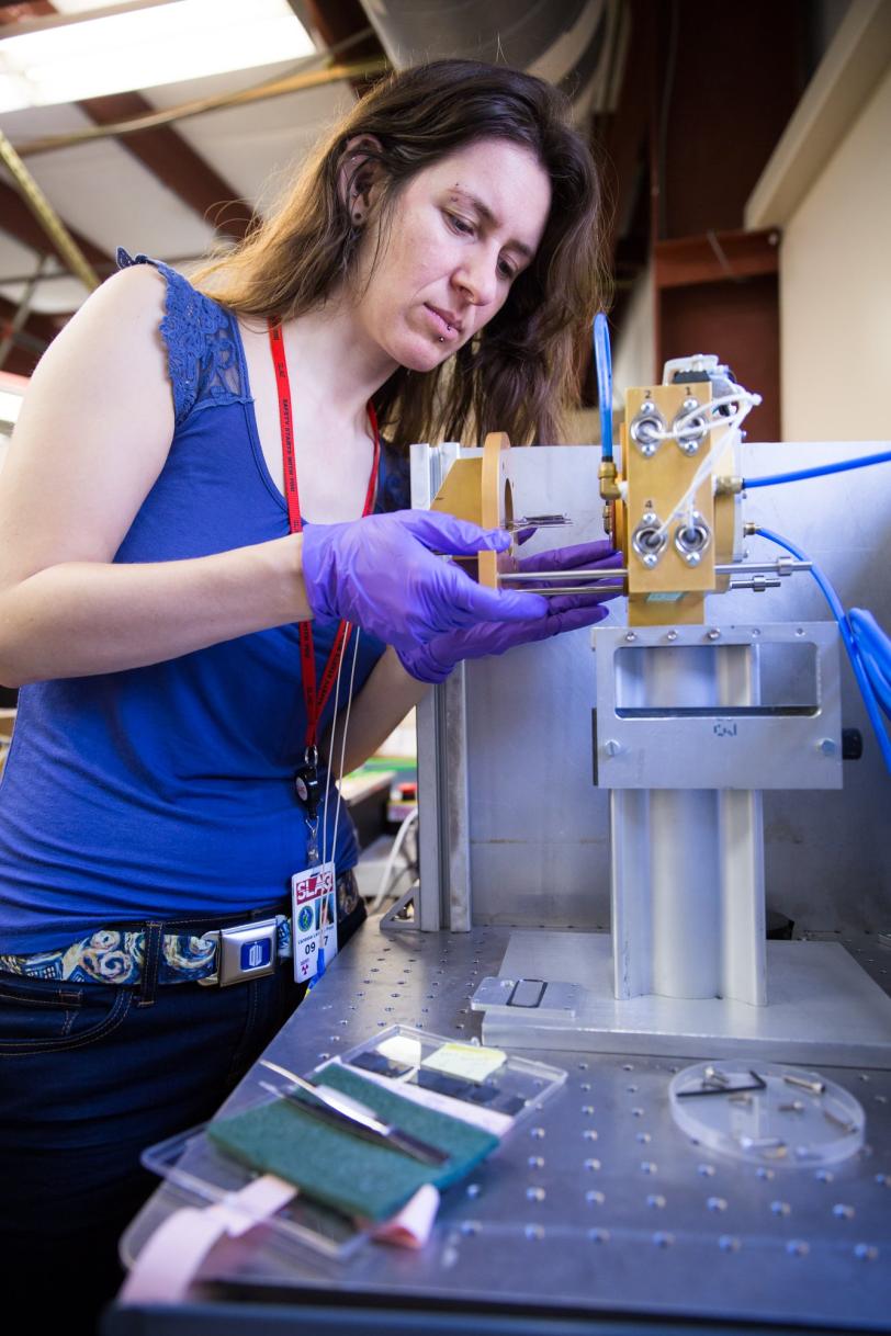 SLAC researcher with equipment used to examine solar cells