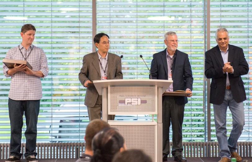 Image - From left, SLAC's Erik Hemsing, Zhirong Huang and William Fawley accept awards during the 36th International Free Electron Laser Conference in Basel, Switzerland. At right is SLAC's Paul Emma, who served as this year's FEL Prize committee chairman