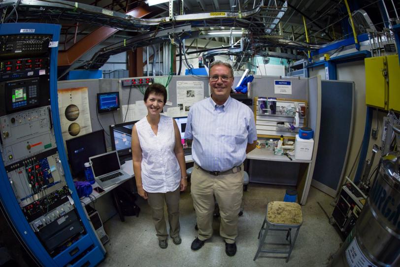 Image - Ingrid Pickering and Graham George, a husband-and-wife X-ray research team, stand next to the controls of SSRL Beam Line 7-3 during a research sabbatical at SLAC. (SLAC National Accelerator Laboratory)