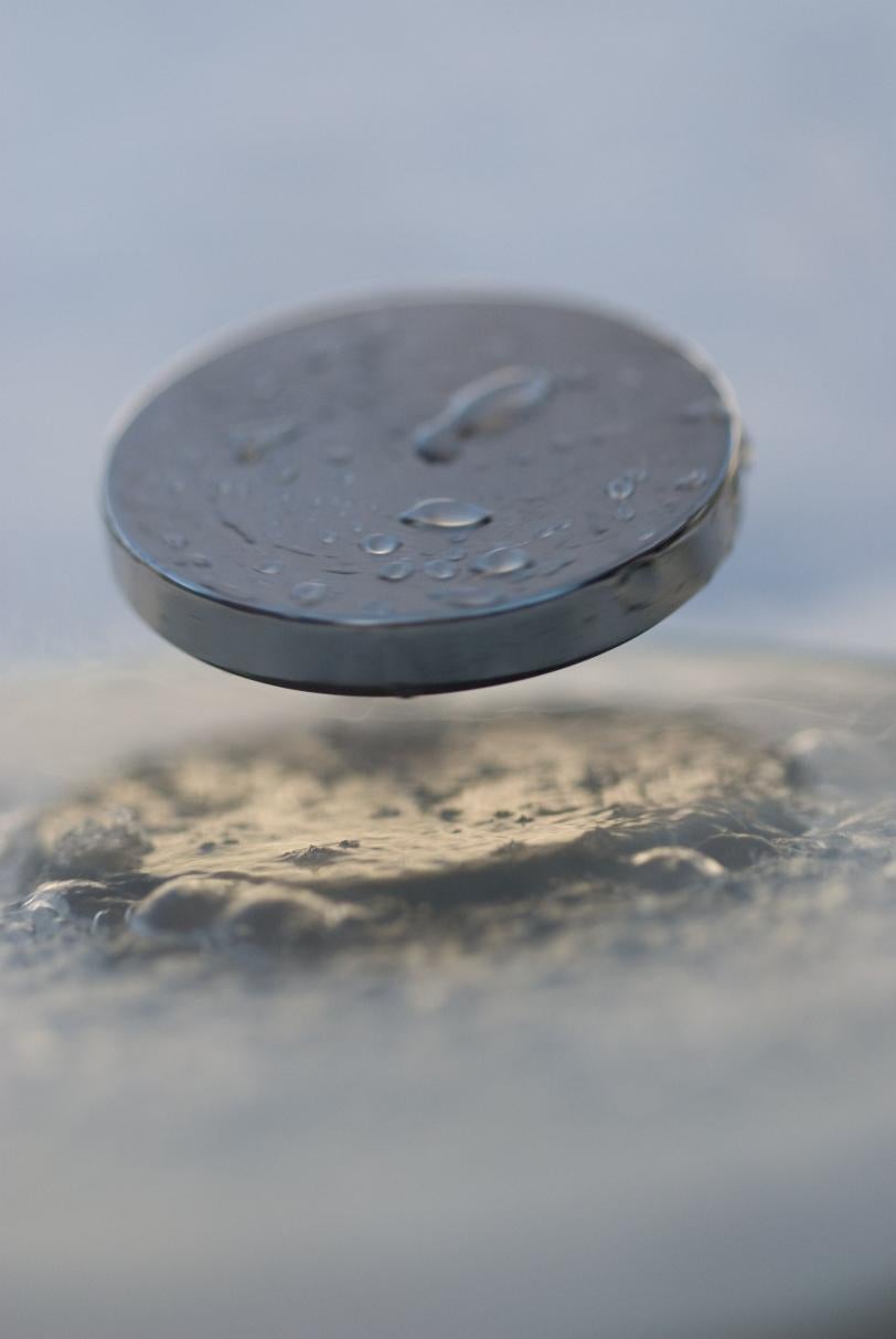 Image of a small magnet levitating above a superconducting material 