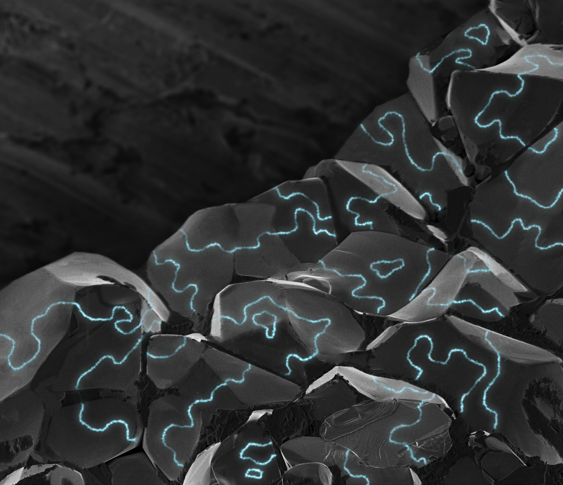 An illustration of electrically conductive areas (blue) along the boundaries of tiny magnetic regions, or domains, in chunky grains of a material that normally doesn’t conduct electricity.