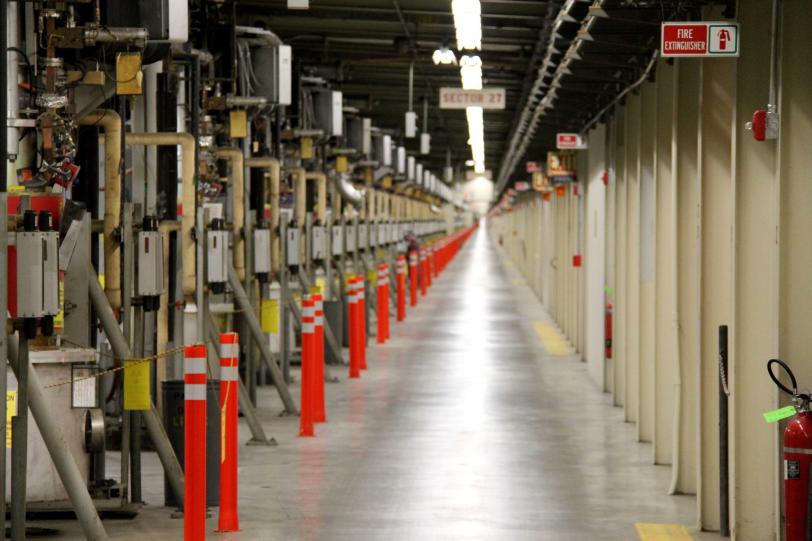 Image - SLAC's Klystron Gallery is a nearly 2-mile-long building that sits above the linear accelerator. The Klystron Gallery houses hundreds of klystrons that generate microwave pulses used as accelerating energy for the electron beam. (SLAC)