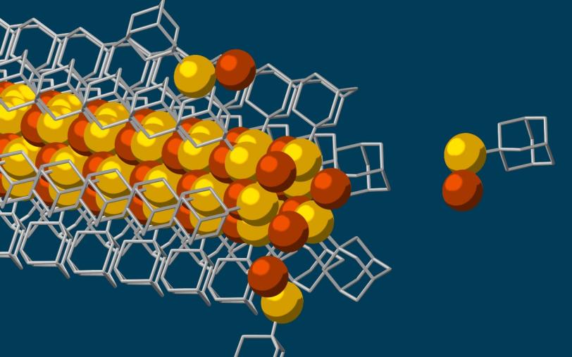 An illustration shows diamondoid building block approaching the tip of a growing nanowire