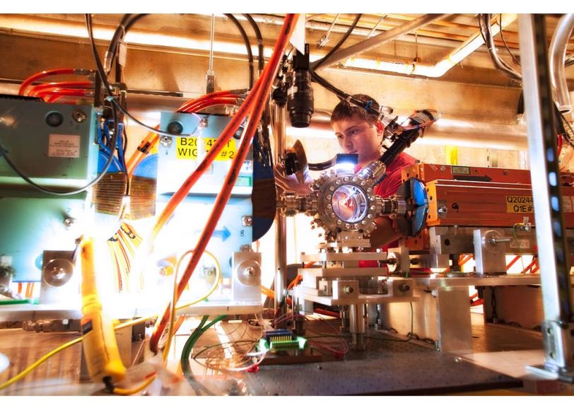 Spencer Gessner aligns a mirror for FACET's X-ray spectrometer