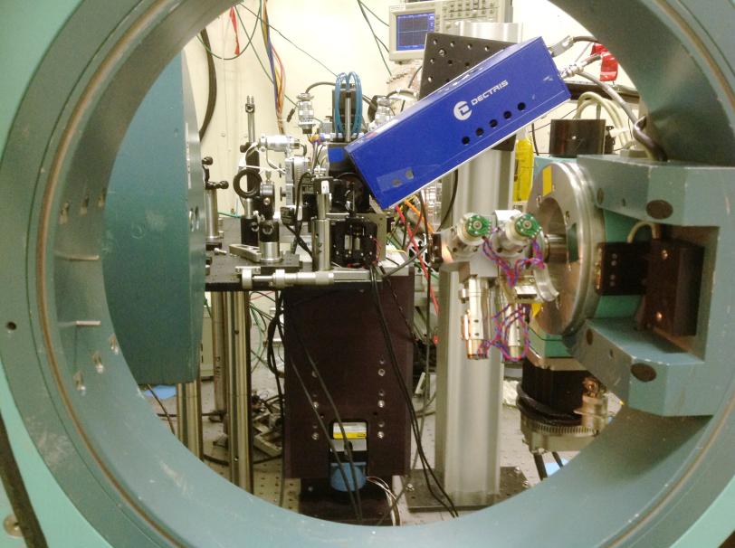Photo - A view of a materials science experimental setup at SLAC's Stanford Synchrotron Radiation Lightsource (SSRL). The circular instrument that frames this photo is part of a diffractometer that was used to align samples and a detector with X-rays.