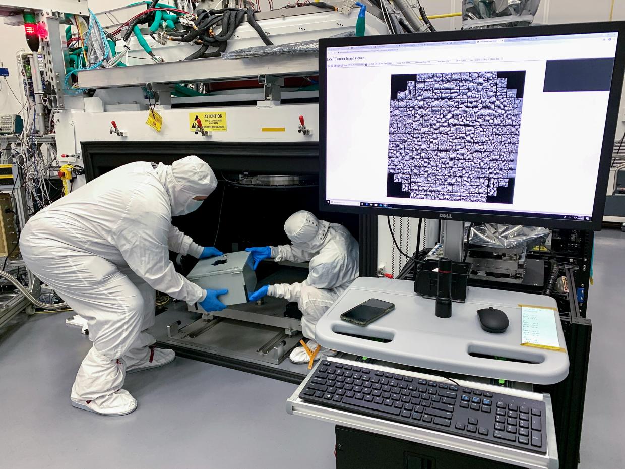 Yousuke Utsumi and Aaron Roodman remove the pinhole projector from the cryostat assembly