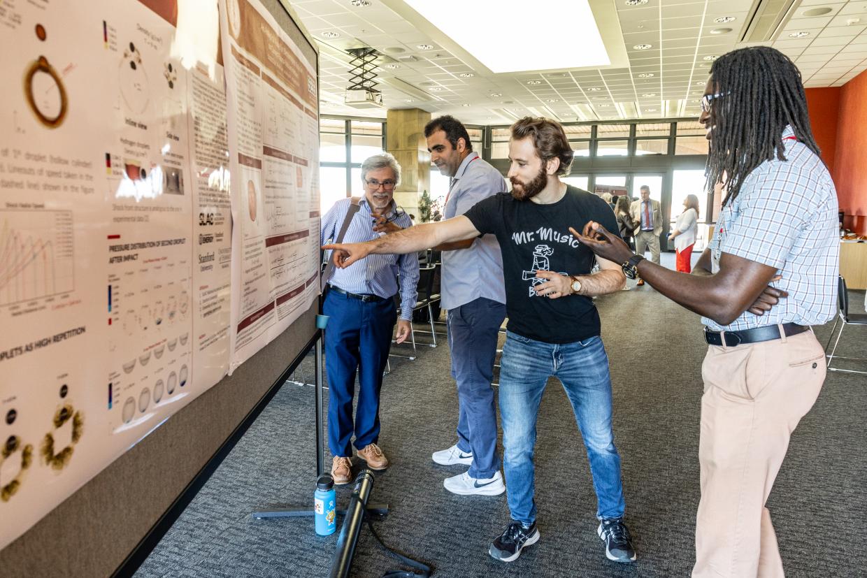 The Stanford-SLAC Extreme Energy Workshop showing their poster session with people explaining their science