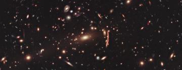 A cluster of bright galaxies on a black background.