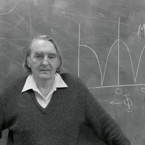 Portrait of Matt Sands in front of chalkboard.
