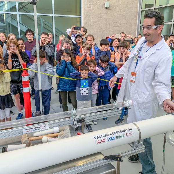 Visitors watch a science demonstration at Community Day 2019