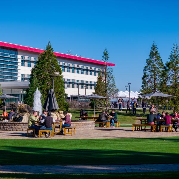 Staff members at SLAC having lunch on the main quad outside the Science and User Support Building