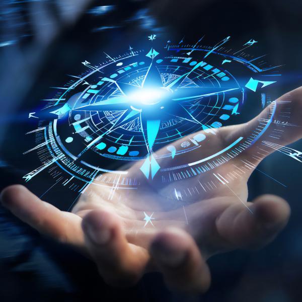 Hand holding a compass made with blue light