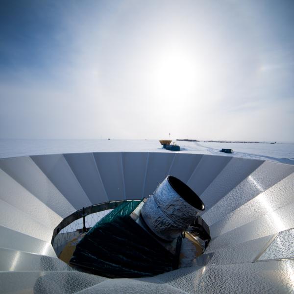 A telescope pokes out from a metal dish.