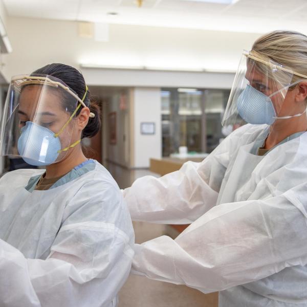 Medical workers donning personal protective equipment