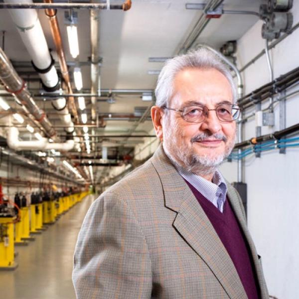 Image - Claudio Pellegrini stands in the Linac Coherent Light Source Beam Transport Hall. The accelerated electron beam passes through here to the Undulator Hall, where electron bunches generate X-rays. (Michelle McCarron)