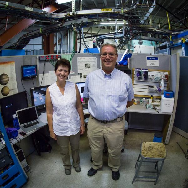 Image - Ingrid Pickering and Graham George, a husband-and-wife X-ray research team, stand next to the controls of SSRL Beam Line 7-3 during a research sabbatical at SLAC. (SLAC National Accelerator Laboratory)