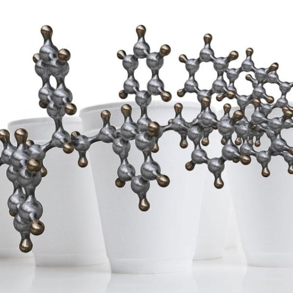 Illustration of a polystrene molecular chain and Styrofoam cups, which are made of polystyrene.